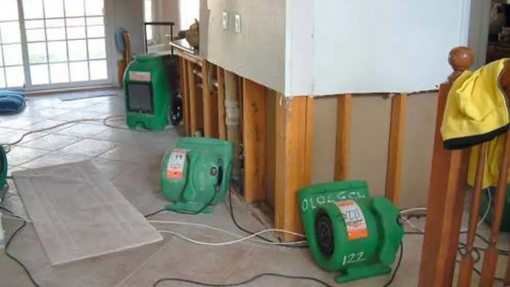 Air movers drying a room with the lower wall cut open